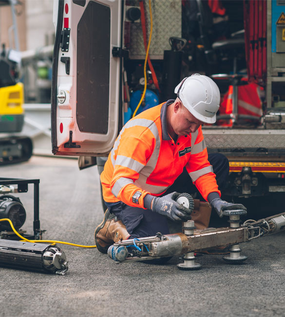 Engineer working on new equipment in high vis and hard hat