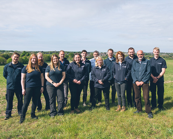 Catchment management team stood in a field smiling